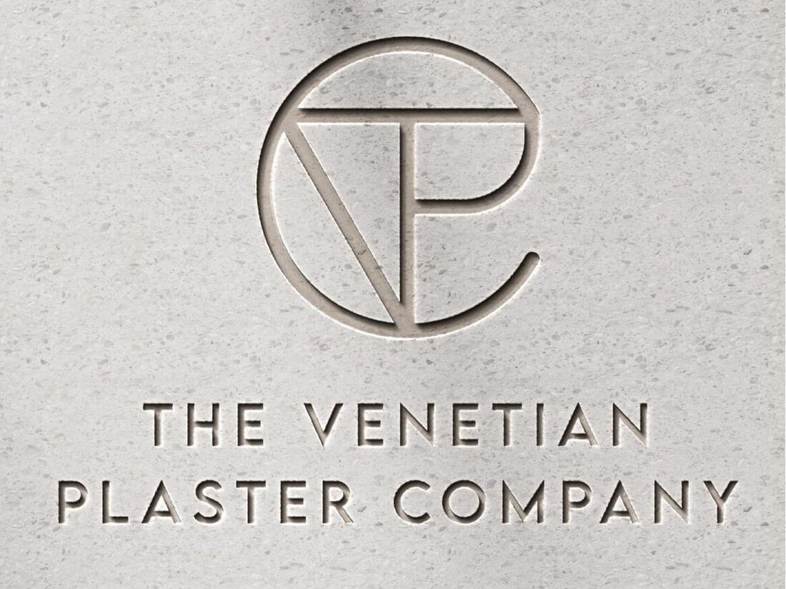 The Venetian Plaster Company monogram debossed into a polished mineral plaster surface